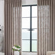 bright living room with modern floor lamp trends and sheer curtains by a window