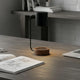 Modern desk lamp buying guide featuring a stylish black lamp on a minimalist desk with sketches and a laptop.