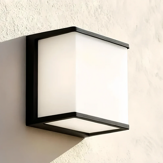 Modern outdoor wall lighting ideas featuring a sleek square light fixture on a textured wall.